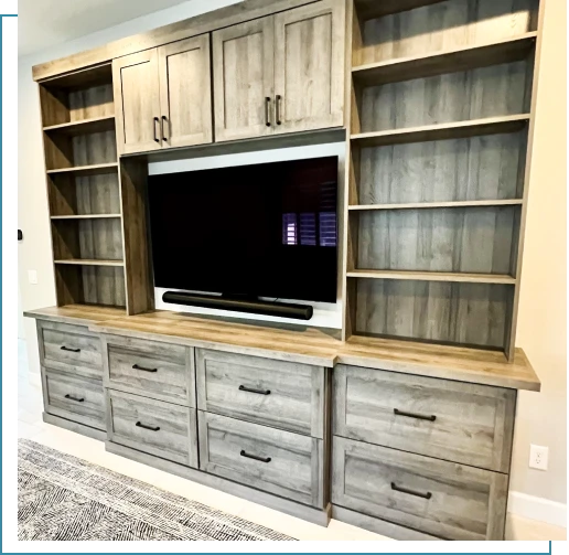 A large entertainment center with a flat screen tv.